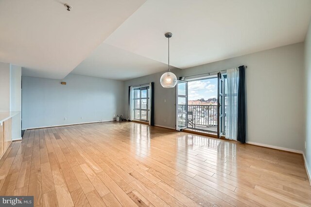 250 President St Unit 1001, Baltimore, MD 21202 - unfurnished dining area with light wood-type flooring and baseboards