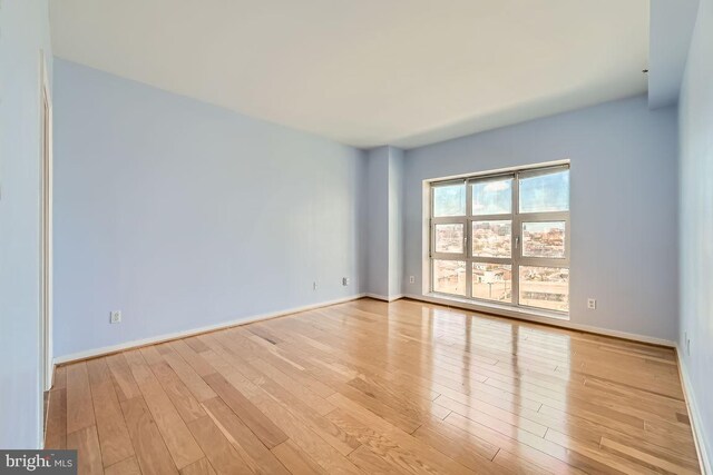 250 President St Unit 1001, Baltimore, MD 21202 - empty room with wood finished floors and baseboards