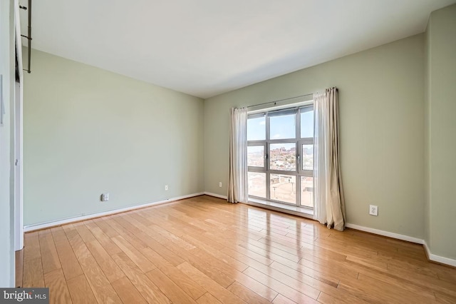 250 President St Unit 1001, Baltimore, MD 21202 - spare room with baseboards and light wood-type flooring