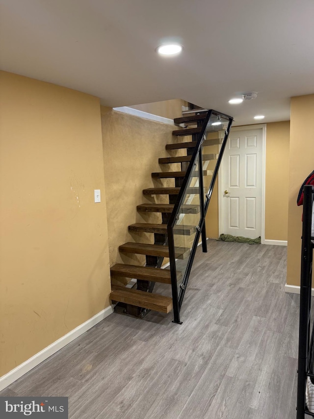 stairs with baseboards, recessed lighting, and wood finished floors