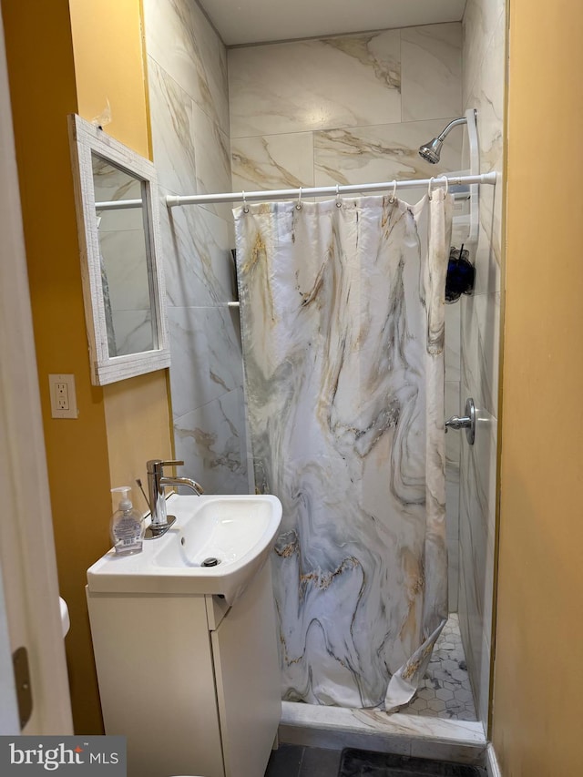 full bath with a stall shower and vanity