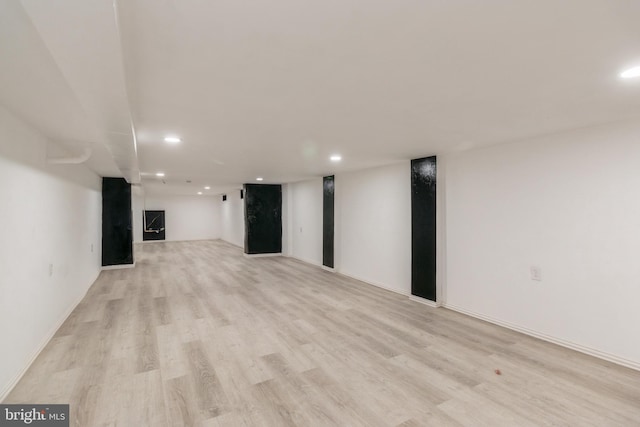 finished basement with light wood finished floors, baseboards, and recessed lighting