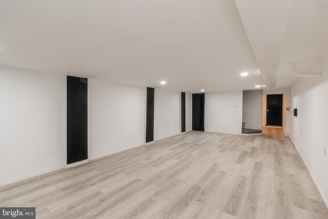 finished basement with recessed lighting and light wood-style floors