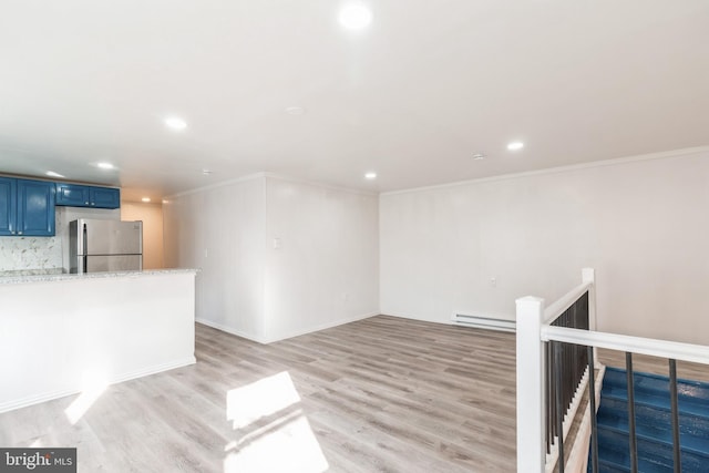 unfurnished living room with crown molding, light wood-style flooring, recessed lighting, and baseboard heating