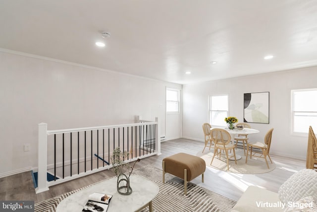 interior space featuring recessed lighting, baseboards, ornamental molding, and wood finished floors