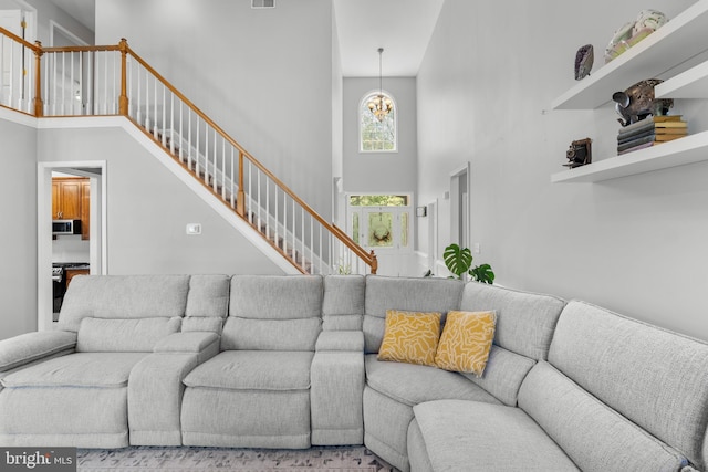 145 Rolling Ave, North East, MD 21901 - living area featuring a towering ceiling, stairs, and a chandelier