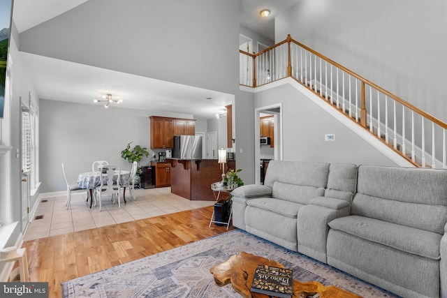 145 Rolling Ave, North East, MD 21901 - living room with light wood-style flooring, high vaulted ceiling, and stairs