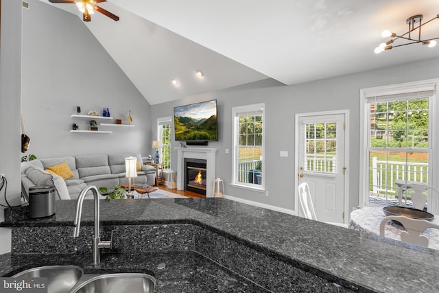 145 Rolling Ave, North East, MD 21901 - living room featuring a fireplace with flush hearth, a ceiling fan, vaulted ceiling, and a chandelier