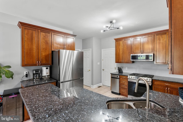 145 Rolling Ave, North East, MD 21901 - kitchen with stainless steel appliances, light tile patterned floors, a sink, and dark stone countertops