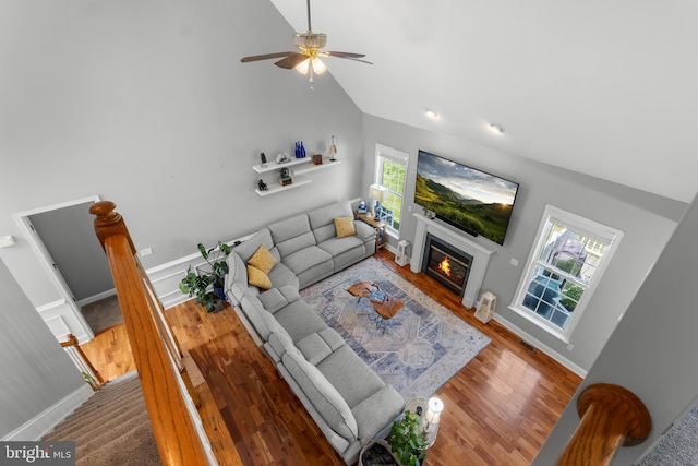 145 Rolling Ave, North East, MD 21901 - living room featuring a glass covered fireplace, vaulted ceiling, wood finished floors, ceiling fan, and baseboards