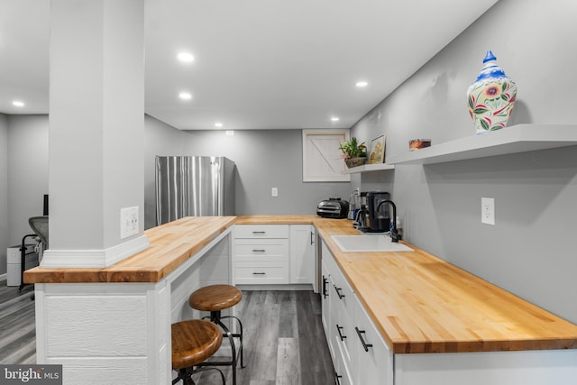 145 Rolling Ave, North East, MD 21901 - kitchen featuring wooden counters, open shelves, a sink, dark wood-type flooring, and a breakfast bar