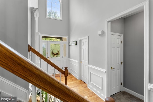 145 Rolling Ave, North East, MD 21901 - staircase with healthy amount of natural light, a wainscoted wall, a decorative wall, and a towering ceiling