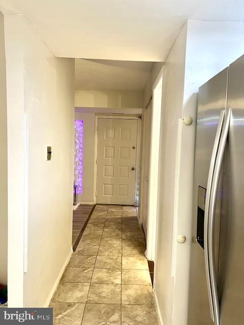 corridor featuring baseboards