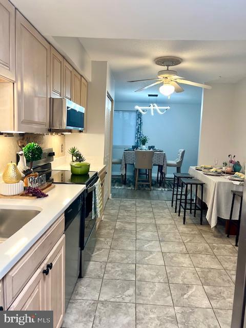kitchen featuring stainless steel microwave, range with electric stovetop, light countertops, ceiling fan, and dishwasher