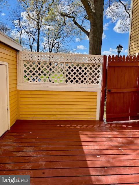 wooden terrace with a gate and fence
