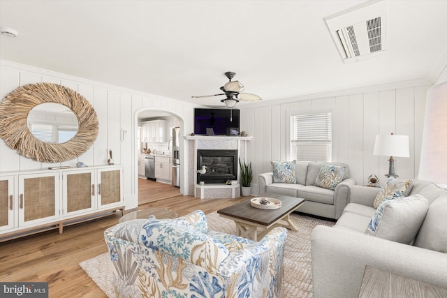 12353 Meadow Dr, Berlin, MD 21811 - living room with visible vents, arched walkways, ornamental molding, a ceiling fan, and light wood-style floors