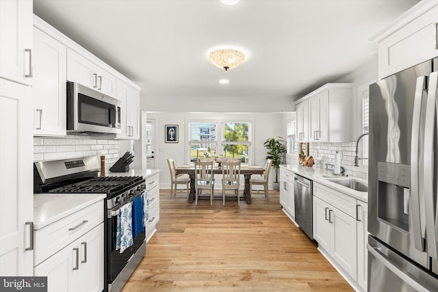 12353 Meadow Dr, Berlin, MD 21811 - kitchen featuring decorative backsplash, light countertops, white cabinets, and stainless steel appliances