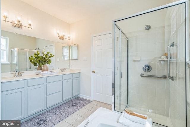 full bath with tile patterned floors, a shower stall, double vanity, and a sink