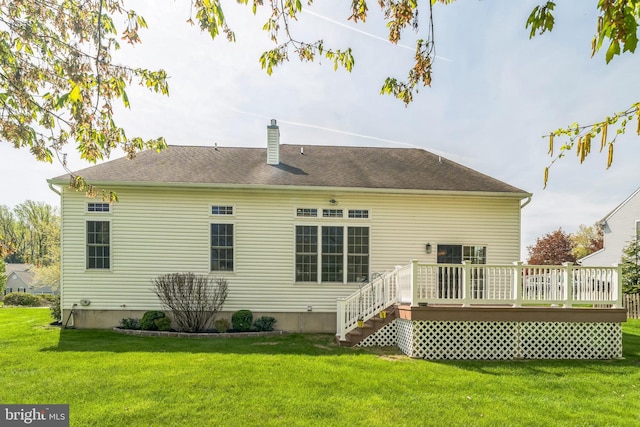 back of property featuring a lawn, a wooden deck, and a chimney