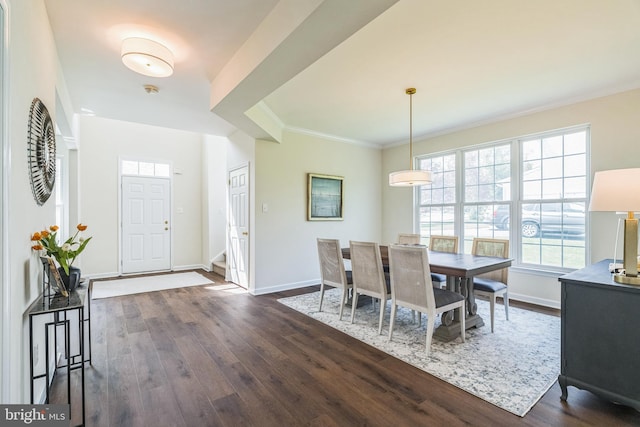 dining room with ornamental molding, dark wood-style floors, and baseboards