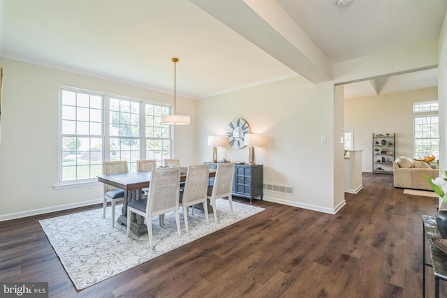 dining space with baseboards, visible vents, crown molding, and dark wood-type flooring