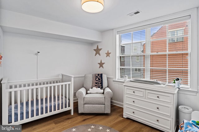 929 S 2nd St, Philadelphia, PA 19147 - bedroom with wood finished floors, a crib, and multiple windows