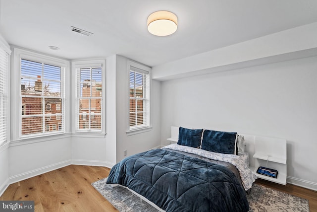 929 S 2nd St, Philadelphia, PA 19147 - bedroom with wood finished floors, baseboards, and multiple windows