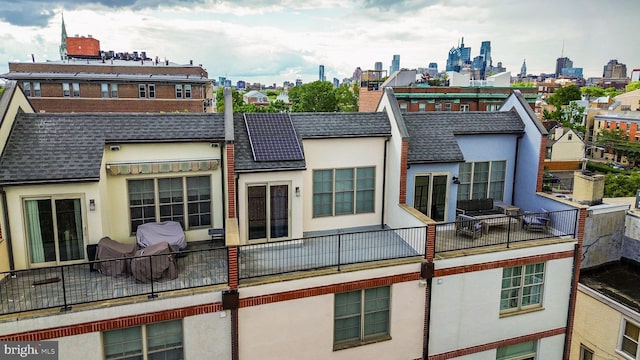 929 S 2nd St, Philadelphia, PA 19147 - rear view of house featuring roof with shingles, a view of skyline, stucco siding, and a balcony