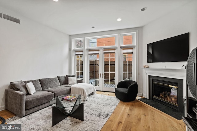 929 S 2nd St, Philadelphia, PA 19147 - living room featuring french doors, wood finished floors, a fireplace with flush hearth, and recessed lighting
