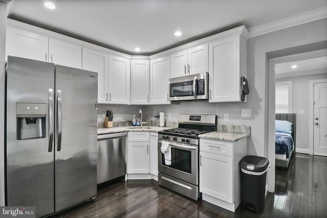 1423 Howard Rd SE, Washington, DC 20020 - kitchen featuring appliances with stainless steel finishes, crown molding, a sink, dark wood-style floors, and white cabinets