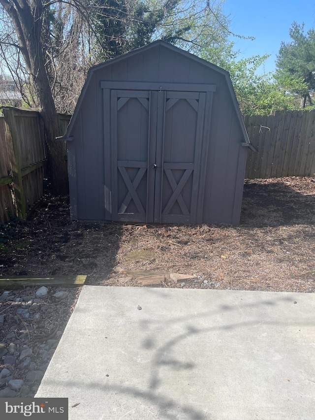 view of shed featuring fence