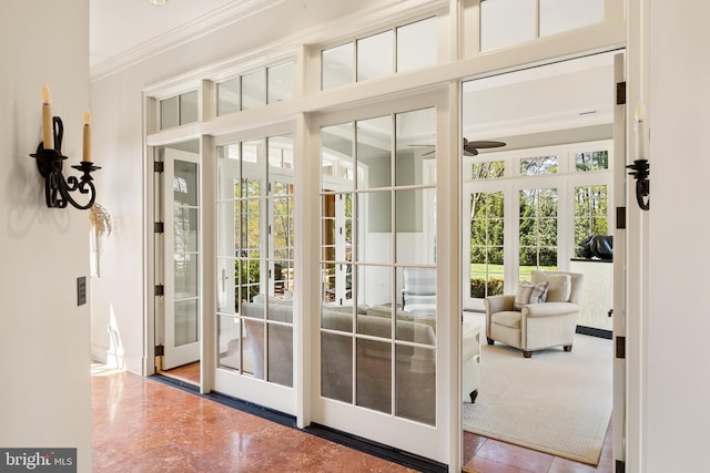 doorway to outside with crown molding and a ceiling fan