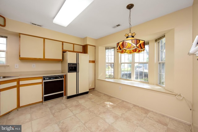 kitchen with white refrigerator with ice dispenser, visible vents, a wealth of natural light, and dishwasher
