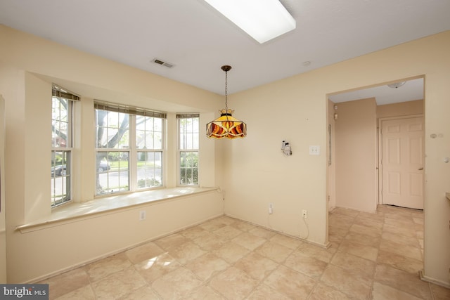 unfurnished dining area featuring visible vents