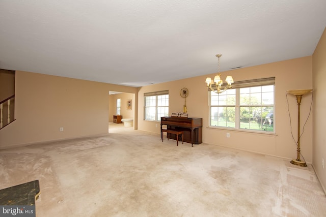 interior space featuring an inviting chandelier, carpet, baseboards, and stairs