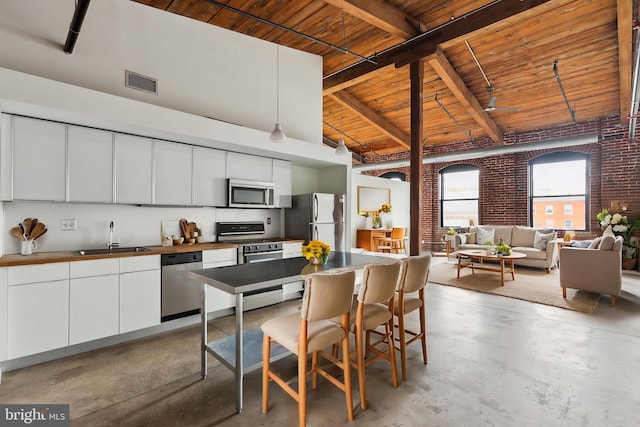 1714 Memphis St Unit 402, Philadelphia, PA 19125 - kitchen featuring concrete floors, wooden ceiling, visible vents, stainless steel appliances, and a sink