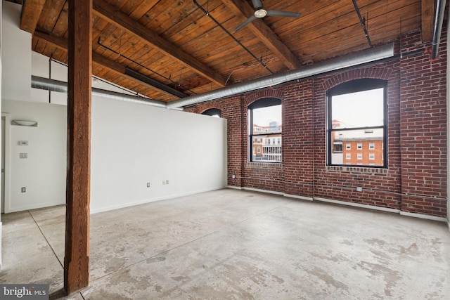 1714 Memphis St Unit 402, Philadelphia, PA 19125 - spare room featuring a ceiling fan, unfinished concrete floors, wood ceiling, brick wall, and beam ceiling