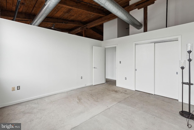 1714 Memphis St Unit 402, Philadelphia, PA 19125 - unfurnished bedroom featuring high vaulted ceiling, concrete floors, a closet, and baseboards