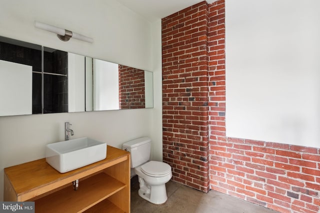 1714 Memphis St Unit 402, Philadelphia, PA 19125 - bathroom featuring brick wall, vanity, and toilet