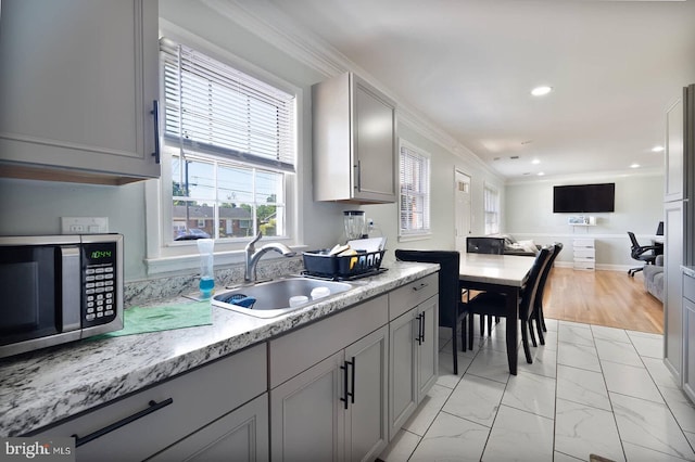 9444 Lafayette Ave, Manassas, VA 20109 - kitchen with stainless steel microwave, a sink, gray cabinetry, crown molding, and healthy amount of natural light