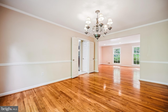 9127 Friars Rd, Bethesda, MD 20817 - empty room with light wood finished floors, a chandelier, baseboards, and ornamental molding