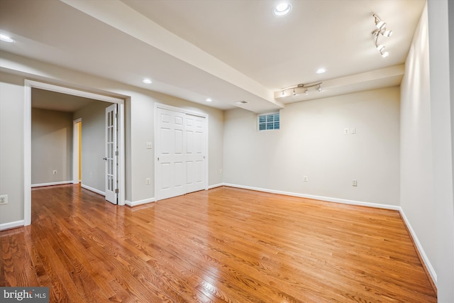 9127 Friars Rd, Bethesda, MD 20817 - finished basement with light wood-style floors, baseboards, track lighting, and recessed lighting