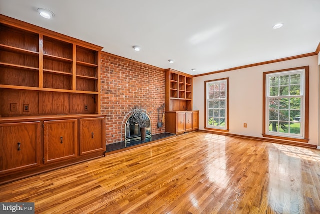 9127 Friars Rd, Bethesda, MD 20817 - unfurnished living room with light wood-style floors, a fireplace, baseboards, crown molding, and built in features