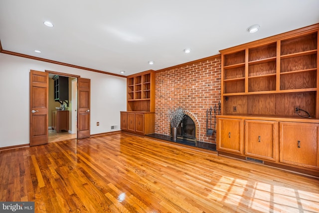 9127 Friars Rd, Bethesda, MD 20817 - unfurnished living room featuring ornamental molding, baseboards, light wood-type flooring, a brick fireplace, and recessed lighting