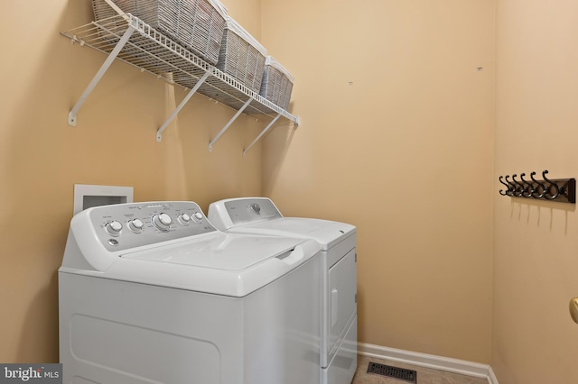 laundry room featuring visible vents, separate washer and dryer, laundry area, and baseboards