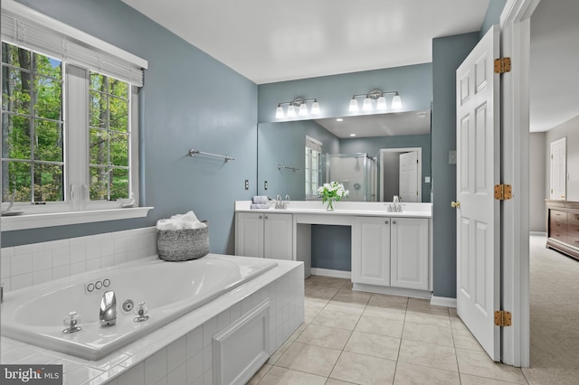 full bath with a shower stall, vanity, a jetted tub, baseboards, and tile patterned flooring