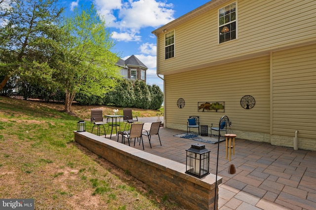 wooden deck with a yard and a patio