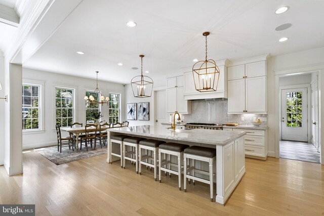 9850 Jerry Ln, Vienna, VA 22180 - kitchen featuring recessed lighting, healthy amount of natural light, light wood finished floors, and backsplash