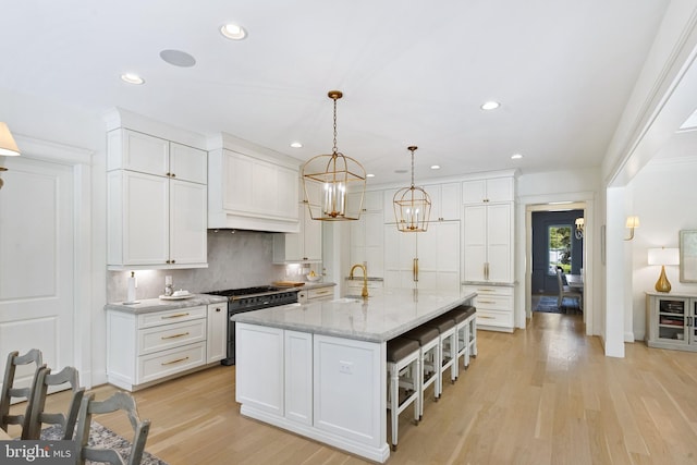 9850 Jerry Ln, Vienna, VA 22180 - kitchen with gas range, recessed lighting, light wood finished floors, a sink, and white cabinets