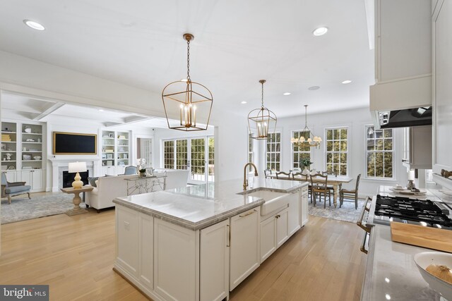 9850 Jerry Ln, Vienna, VA 22180 - kitchen featuring a sink, light wood finished floors, a chandelier, white cabinetry, and recessed lighting
